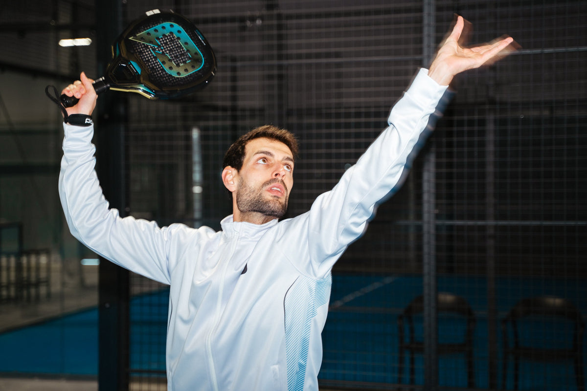 Padel player celebrating with a Pallap racket on an indoor court