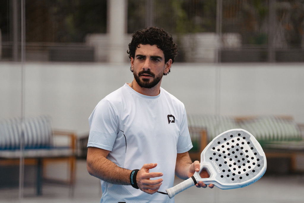 Smiling padel player holding a Pallap racket on court