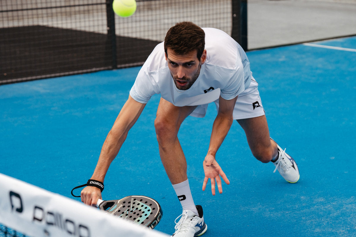 Padel player lunging low for a ball in Pallap apparel and socks